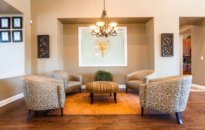 a lounge area with four chairs and a coffee table