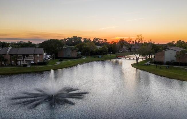 a large pond with a fountain in the middle of it