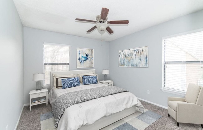 a bedroom with a bed and a ceiling fan