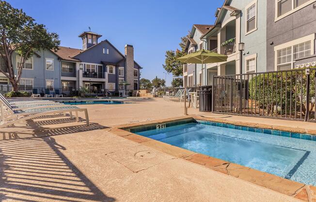 a house with a pool in front of a building