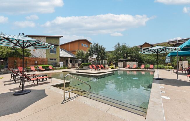 a view of a water park with a pool and buildings at Lakeline East Apartments, Cedar Park