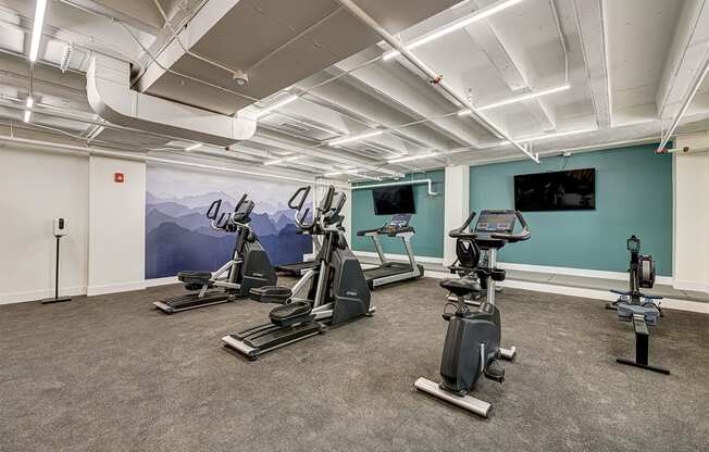 a gym with treadmills and other exercise equipment