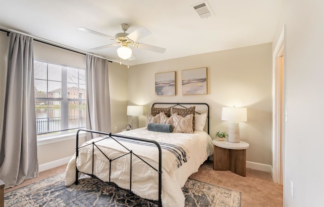 a bedroom with a large bed and a ceiling fan