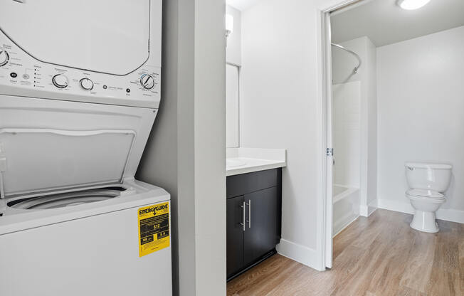 A white washing machine with a yellow sticker on it.