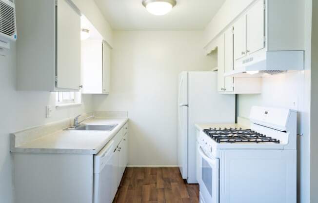 a small kitchen with white appliances and white cabinets