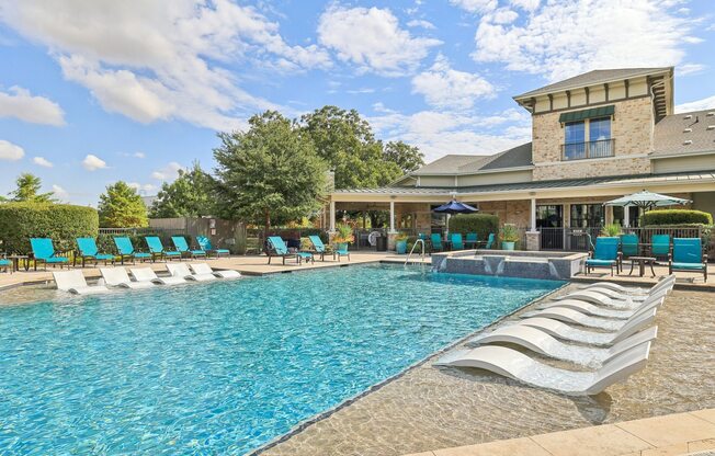 A large swimming pool with a building in the background.