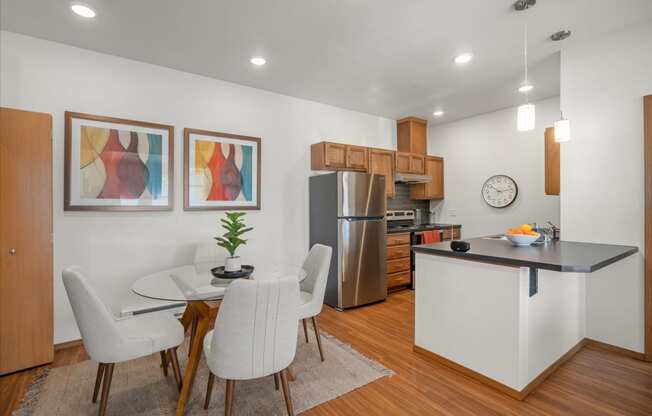 a kitchen and dining room with a table and chairs
