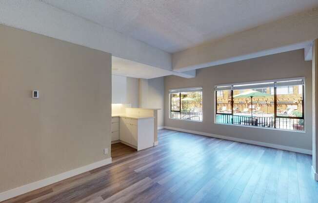 a spacious living room with a view of the pool at the oxford at estonia apartments