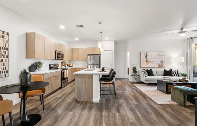 A modern kitchen with wooden floors and a black table.