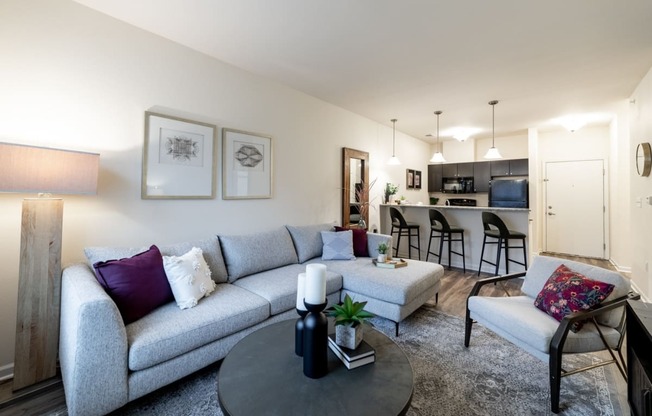 a living room with a couch and a table and a kitchen at 310 at Nulu Apartments-Student, Kentucky, 40202