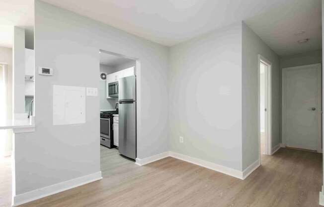 A kitchen with a refrigerator, oven, and microwave.
