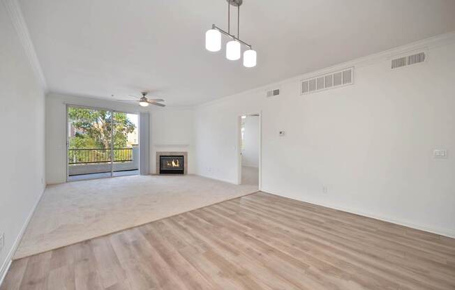 A spacious living room with a fireplace and sliding glass doors.