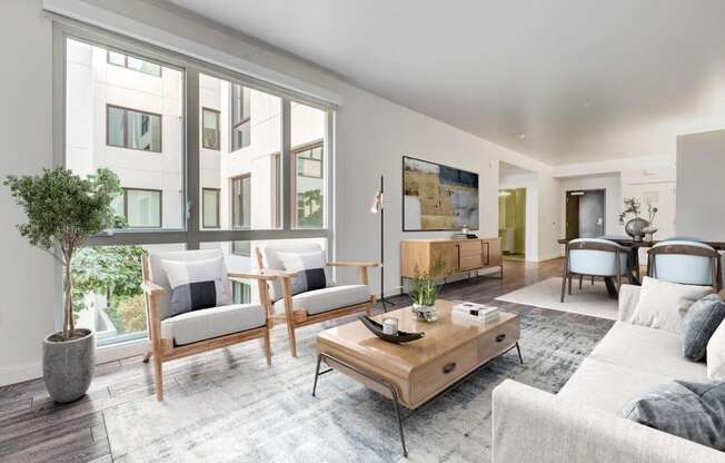 A living room with a couch, chairs, and a coffee table.