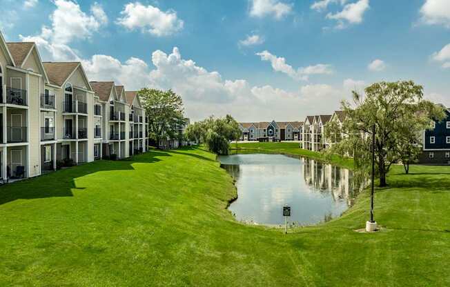 A row of houses with a pond in the foreground