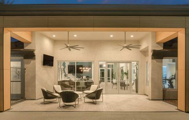 a dining area with chairs and a table in a patio