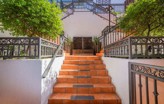 A set of stairs with a metal railing on both sides.