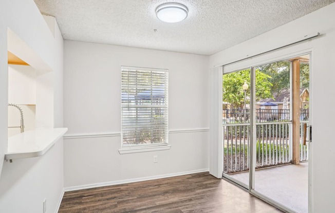 A room with a window and a sliding glass door.