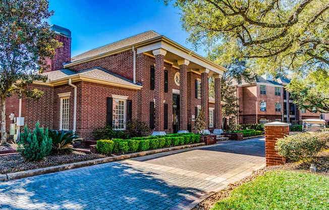 A red brick building with a white door and windows.