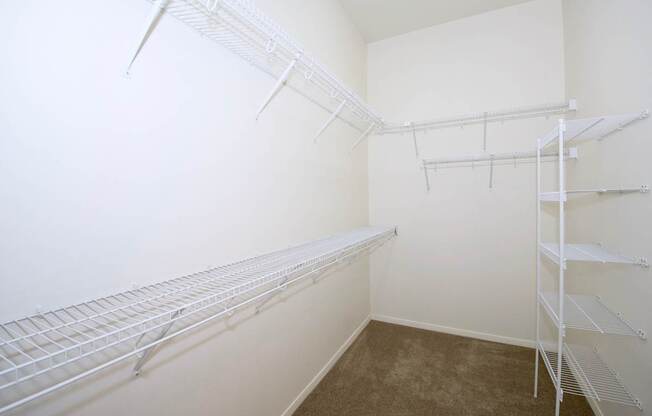Empty white shelving in a room.