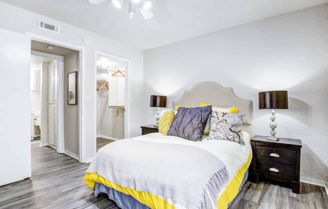 Master bedroom in Edmond, OK apartment for rent with hardwood flooring and overhead ceiling fan