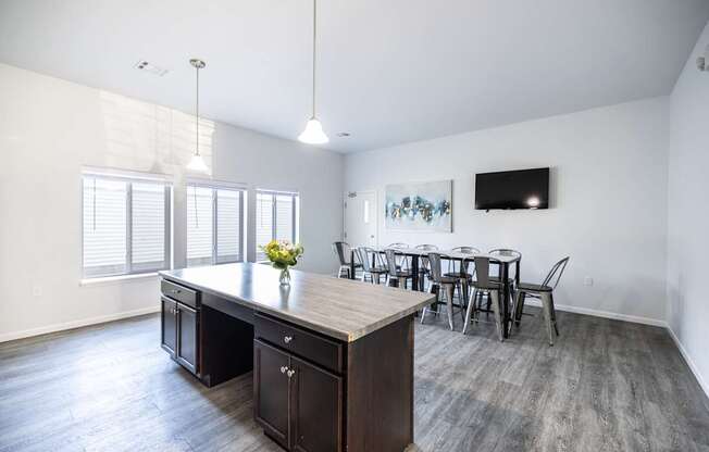 A kitchen with a table and chairs in front of a window.
