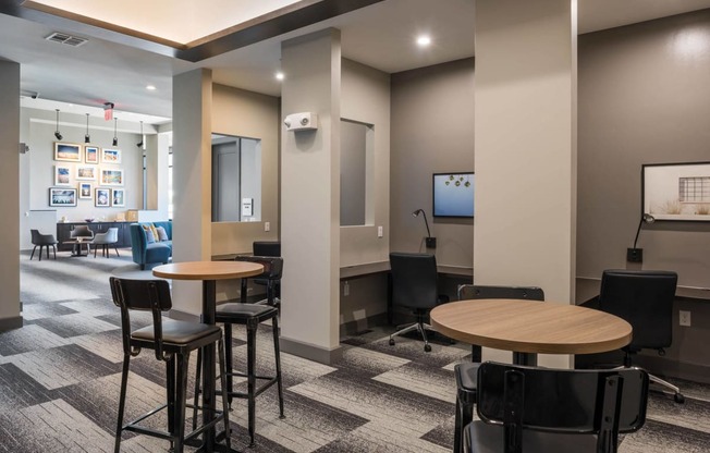 a lounge area with tables and chairs at Tinsley on the Park apartments