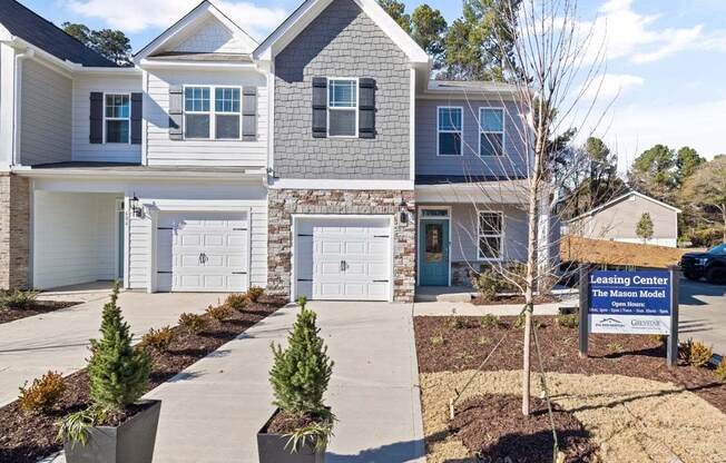 a home for sale with a sign in front of it