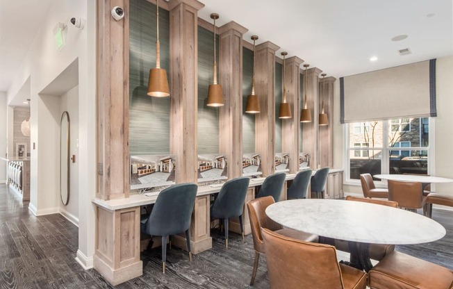A dining room with a long table surrounded by chairs.