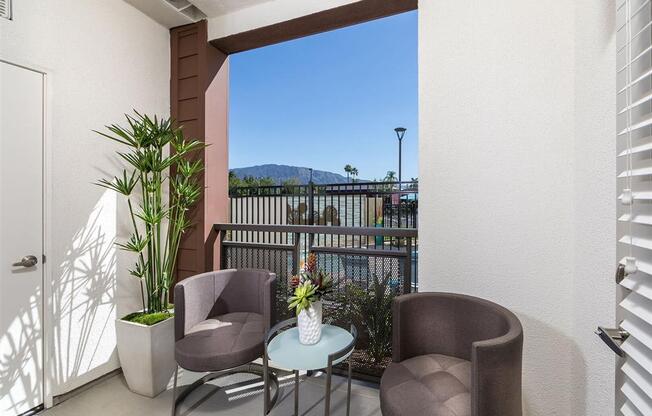 a patio with two chairs and a table