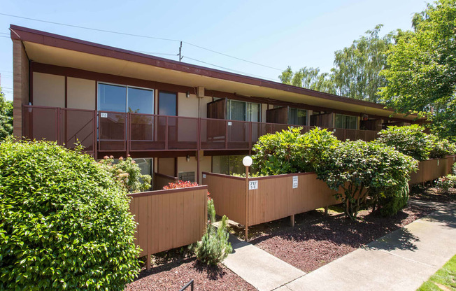 the front of a house with a deck and a garden