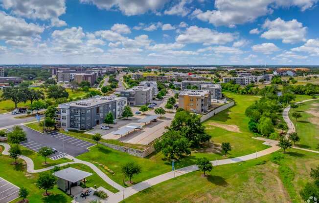 A large building complex with a parking lot in front.