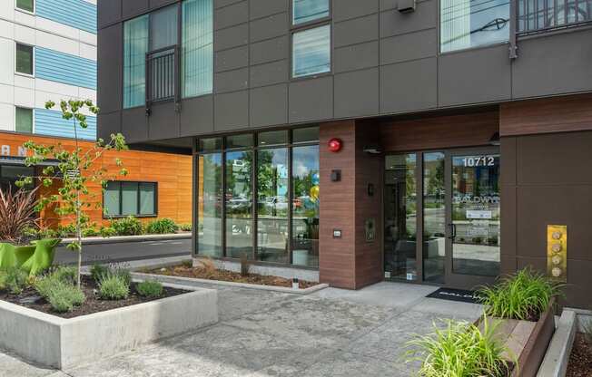The front of a modern building with a red light on.
