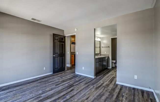 the living room and kitchen of a new home with wood flooring