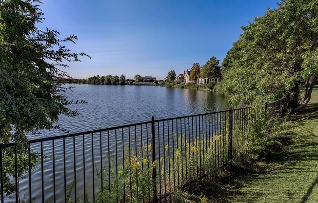 a fence in front of a large body of water