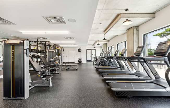 a large fitness room with treadmills and exercise machines at Hydro, Richmond, Virginia