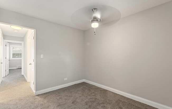 a bedroom with gray walls and carpet at The Hinsdale, Illinois