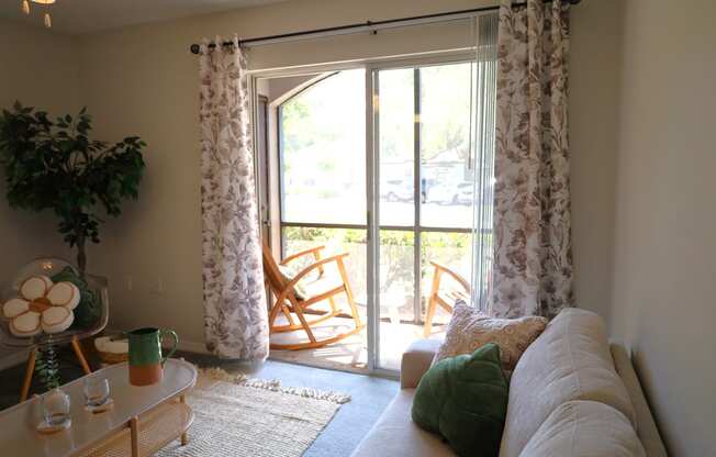 a living room with a couch and a sliding glass door