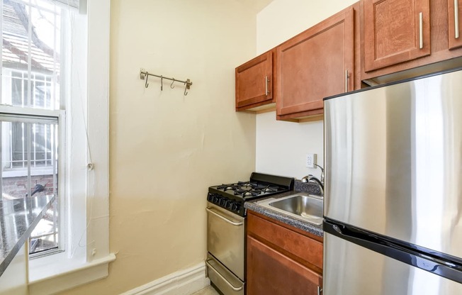 kitchen with stainless steel appliances and large window at dupont apartments in washington dc