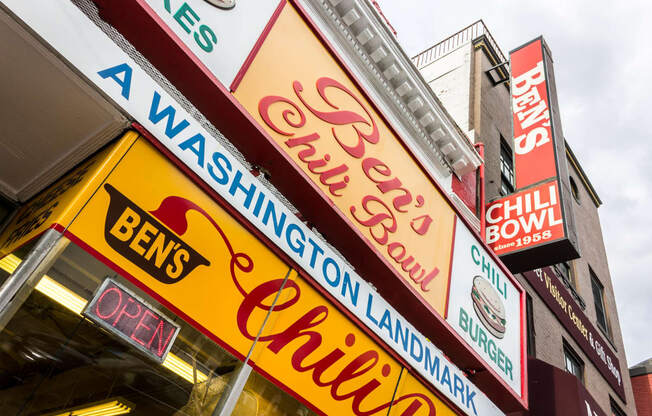 a row of neon signs on the side of a building at The Shay, District of Columbia 20001