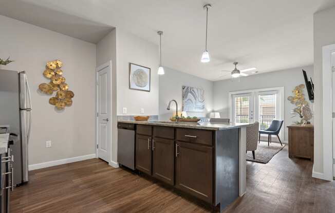 an open kitchen and living room with an island and a dining room table