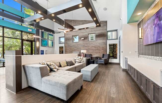 a large living room with couches and a tv