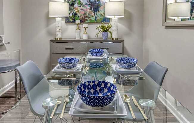 A dining table with blue and white bowls on it.