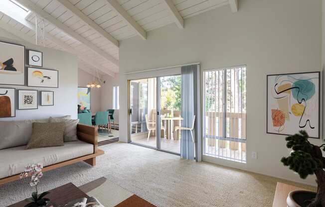 a living room with a couch and a sliding glass door to a patio