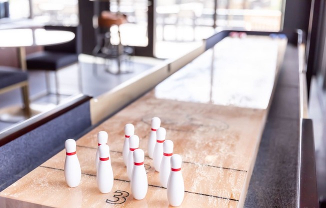 a row of bowling pins on a shuffleboard court at Maven on Broadway, Rochester, MN, 55904