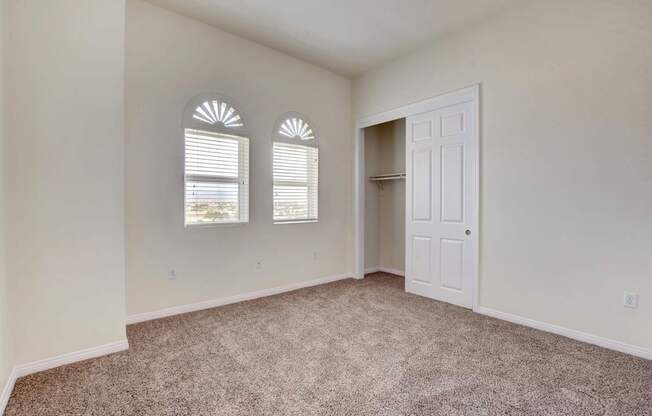 A room with a carpeted floor and a white door.