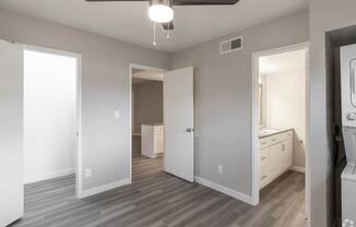 A room with a ceiling fan and a washing machine.