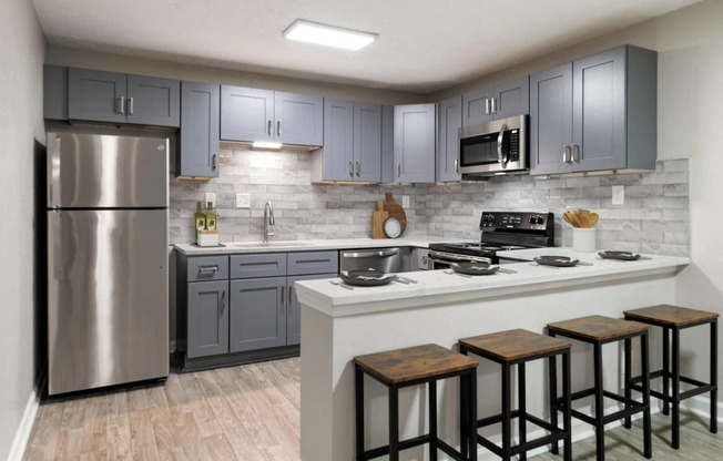 Manchester at Mansell Kitchen with Stainless Steel Appliances and Shaker-Style Cabinets