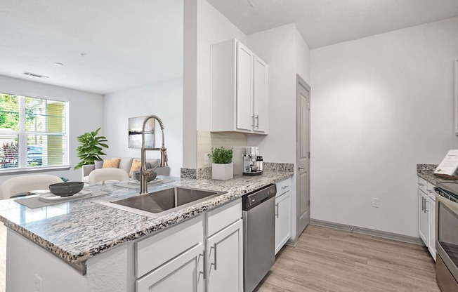 A kitchen with a marble countertop and stainless steel appliances.