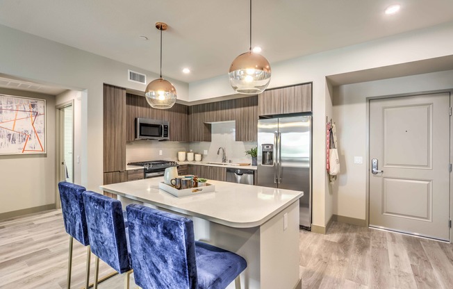 kitchen with vinyl wood like flooring and stainless steel appliances at Arte Apartments
