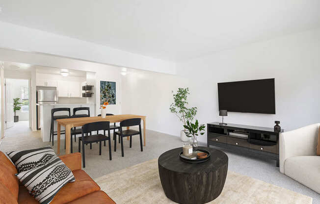 A modern living room with a wooden coffee table and a flat screen TV at North Pointe Apartments, Elkhart